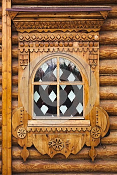 Patterned Windows in the old Russian log hut. Well-developed wood structure of the log.