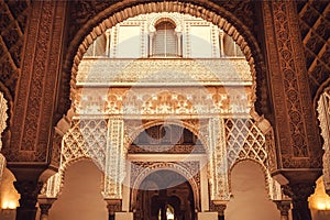 Patternes of the 14th century arches inside Alcazar royal palace in Mudejar architecture style, Seville of Spain