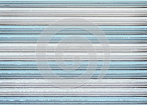 Patterns of colorful old white and blue rolling steel door texture or roller shutter door for background