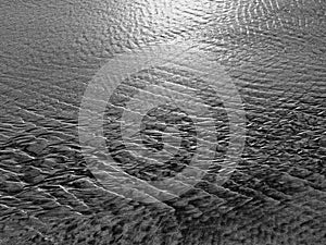 Patterns created ÃÂ¾n the sand by waves and wind