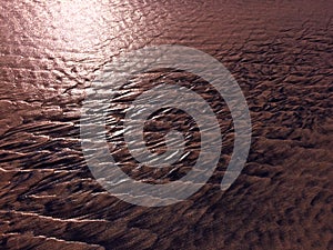 Patterns created ÃÂ¾n the sand by waves and wind, sand pattern as background