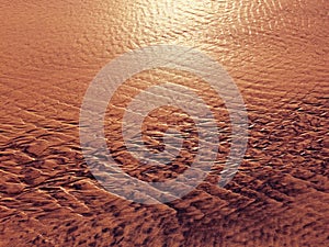 Patterns created ÃÂ¾n the sand by waves and wind