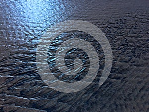 Patterns created ÃÂ¾n the sand by waves and wind, sand pattern as background