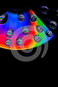 Patterns of light and color created by water drops refracting light/abstract background with rainbow colors and copy space