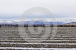 Patterns of Snow In Plowed Fields Mountain Background