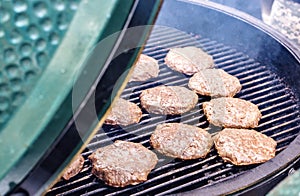 Patties cooking on grill cooker photo