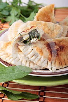 Patties of unleavened dough with greens and cheese