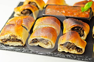 Patty`s pies stuffed with minced meat, mushrooms and onion, served with sauce