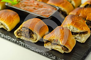 Patty`s pies stuffed with minced meat, mushrooms and onion, served with sauce