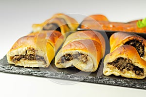 Patty`s pies stuffed with minced meat, mushrooms and onion, served with sauce