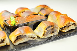 Patty`s pies stuffed with minced meat, mushrooms and onion, served with sauce