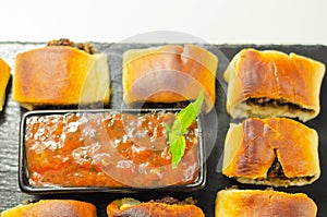 Patty`s pies stuffed with minced meat, mushrooms and onion, served with sauce