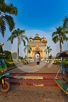 Patuxai Monument Vientiane Laos Girl tourist takes photos of the Victory Gate