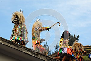 Paucartambo Peru during the procession of the Saqras mischievous devils surround it from the roofs and balconies