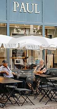 Paul cafe terrace with seniros city summer