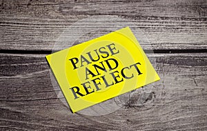 pause and reflect the phrase on yellow paper and pen