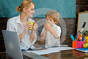 Pause. Snack. School break. The teacher and the boy eat together. After lessons. Lunch at school. Autumn education