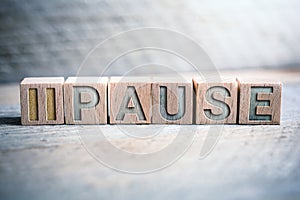 Pause Written On Wooden Blocks On A Board