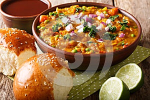 Pav bhaji - popular Indian street food close-up in a bowl. Horizontal