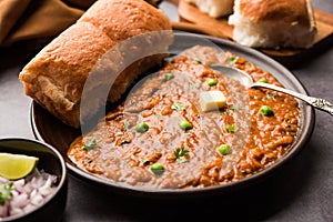 Pav bhaji is a popular Indian street food that consists of a spicy mix vegetable mash & soft buns photo