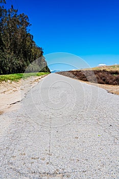 Paved backcountry road under blue sky photo