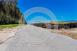 Paved backcountry road under blue sky photo