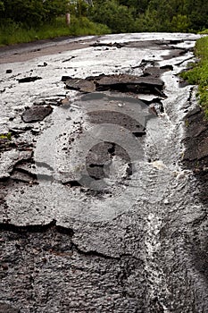 Paved city street destroyed after storm and flood