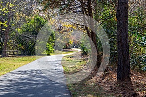 A paved exercise trail winding through an autumn landscape