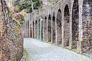 Paved path along the arches in the historic city wall of Bad Muenstereifel