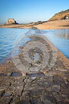 Paved path to Grand Be and Petit Be islands at low tide in Saint Malo, Brittany France