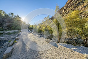 Paved pathway hiking trail along rugged cliffs in the Sabino Canyon Arizona