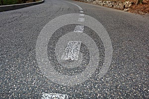 Paved road with dividing line. Focus on foreground