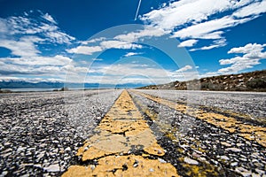 A paved road goes through Antelope Island State Park in Salt Lake City Utah. Very low angle