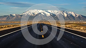 Paved Road Leading to Snow-Capped Wasatch Range