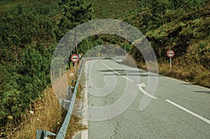 Paved road passing through hilly landscape