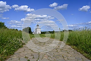 Paved road to the ancient church of Pokrova-na-Nerli, year 1165, on a hill in Bogolyubovo, Russia
