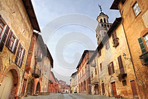 Paved street among historic houses in Saluzzo.