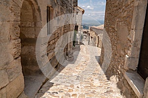 Paved street with old stone houses Lacoste in Provence France