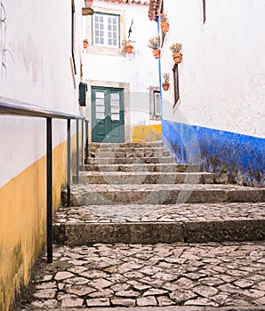 Paved street with steps leading up.
