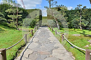 A walkway with roped boundary in a garden photo