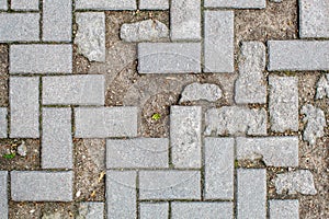 Pavement with broken broken tiles. texture of light gray bricks