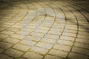 Pavement laid out in a semi-circle of smooth stones. Paving stone, tile, semicircle and circle..