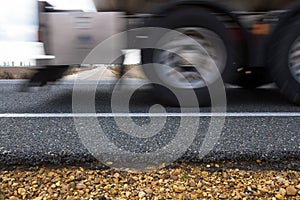 Pavement of a road at ground level through which a truck passes