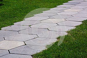 pavement with stone tiles honeycomb pattern on park.