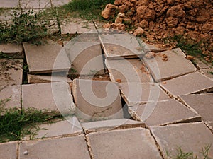 Pavement surfaces are damaged, cracks due to inadequate construction