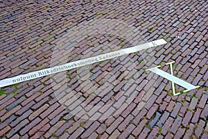 Pavement with x-axis of the Netherlands national triangle system. Dutch text: zero point national triangular measurement photo