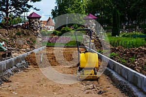 Paver evens out the top layer of sand, builds a path, prepares the road for asphalt.