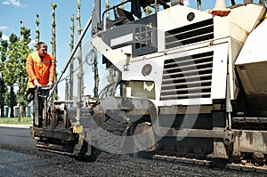 Paver worker at asphalting works