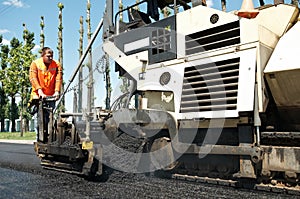 Paver worker at asphalting works photo