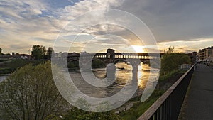 Pavia covered bridge over Ticino river at beautiful sunset